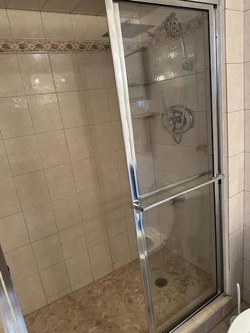 a bathroom with a glass shower door