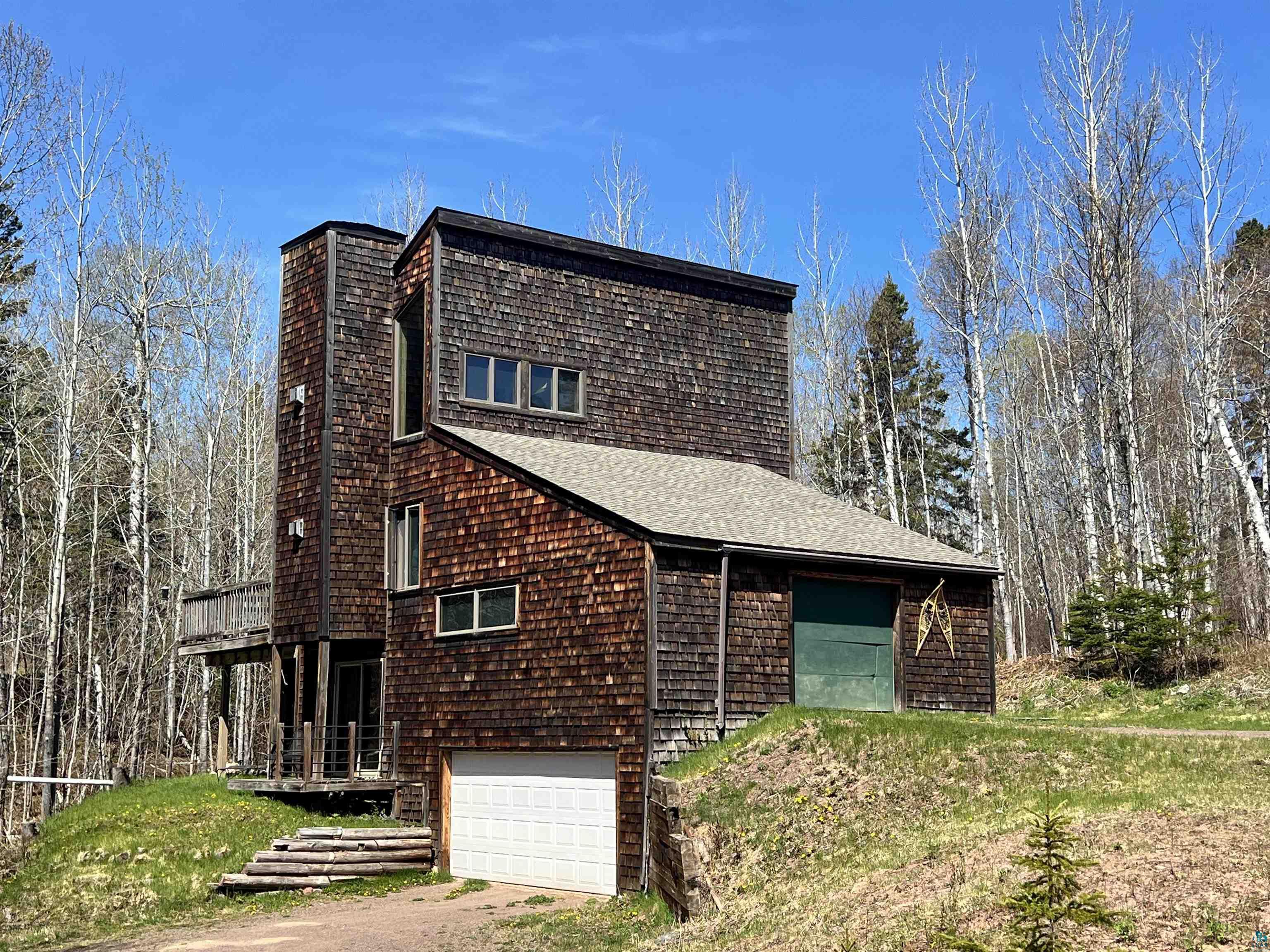 67 Snowshoe Trail Tofte, MN 55615 - Photo 1 of 42 Multi-level residence featuring a shake shingle exterior