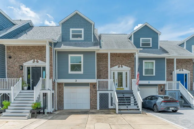 a living room with furniture kitchen view and a large window