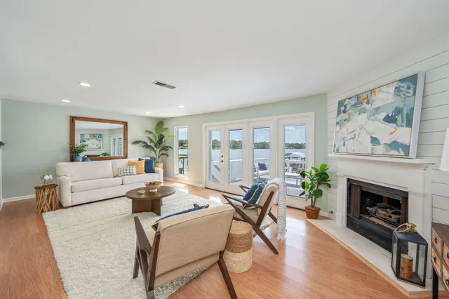 a living room with furniture large window and a fireplace