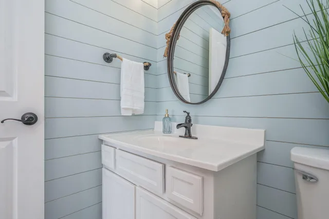 a white bath tub sitting next to a bathroom sink