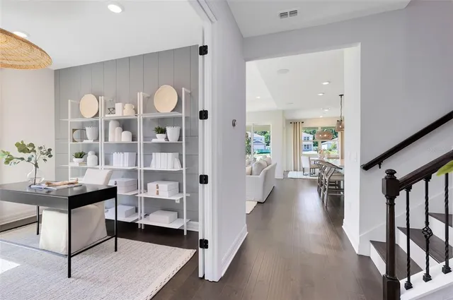 a view of a livingroom with furniture and hardwood floor