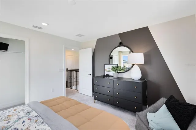 a bedroom with a bed and a dresser