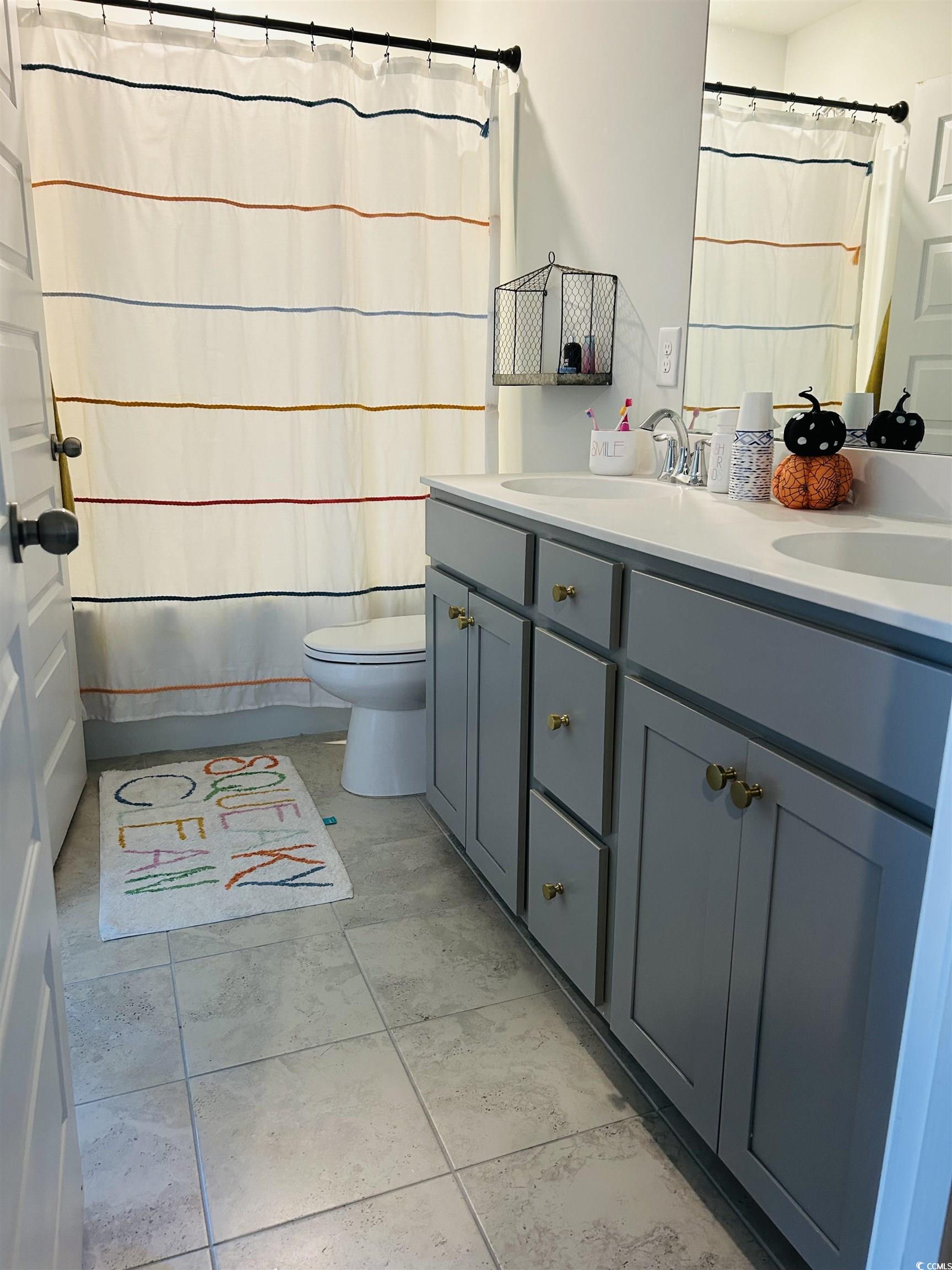 609 Shortleaf Path Myrtle Beach, SC 29577 - Photo 11 of 40 Bathroom featuring double vanity, shower / tub combo, and light tile patterned floors