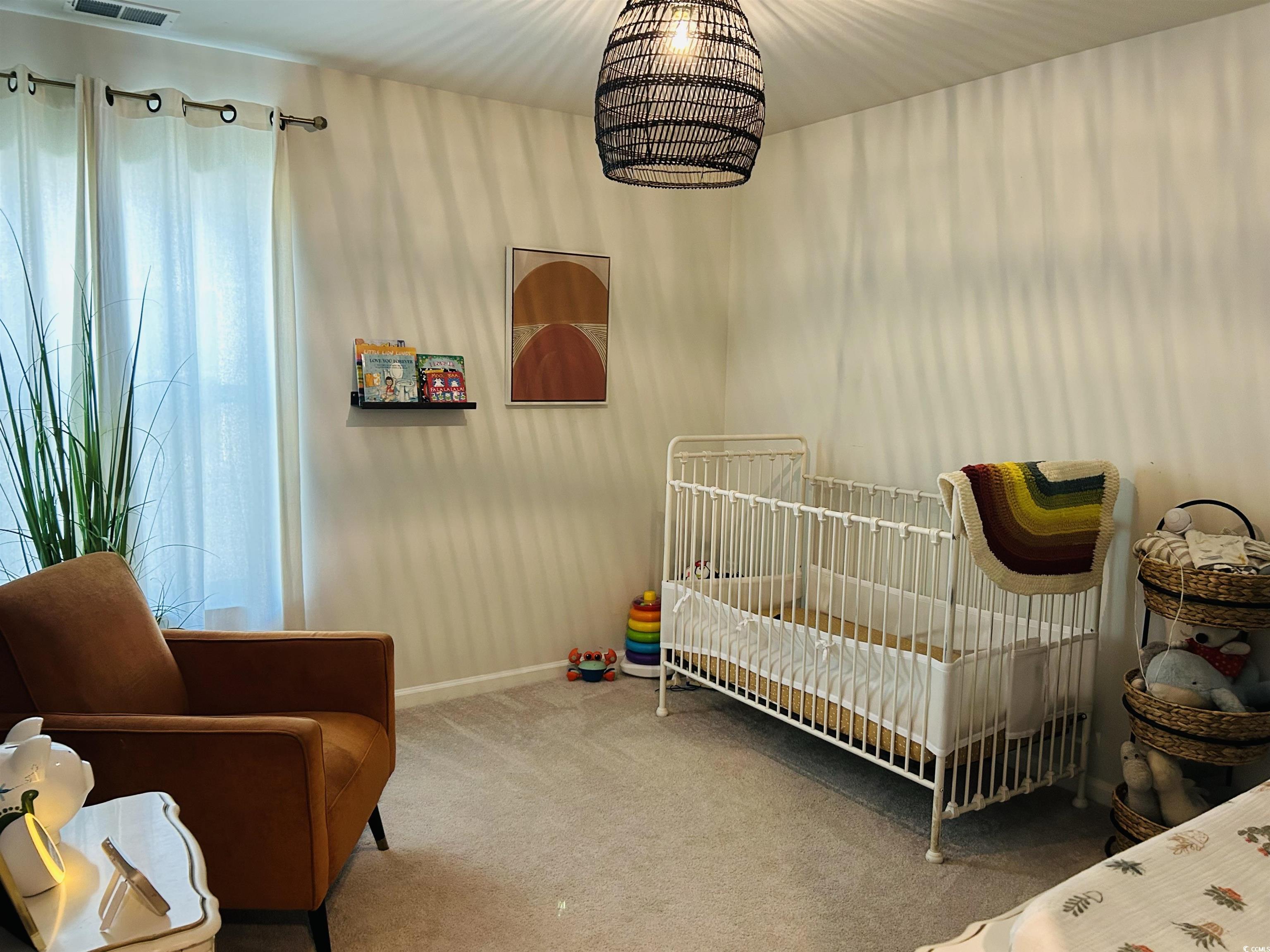 609 Shortleaf Path Myrtle Beach, SC 29577 - Photo 18 of 40 Bedroom with carpet flooring and a nursery area