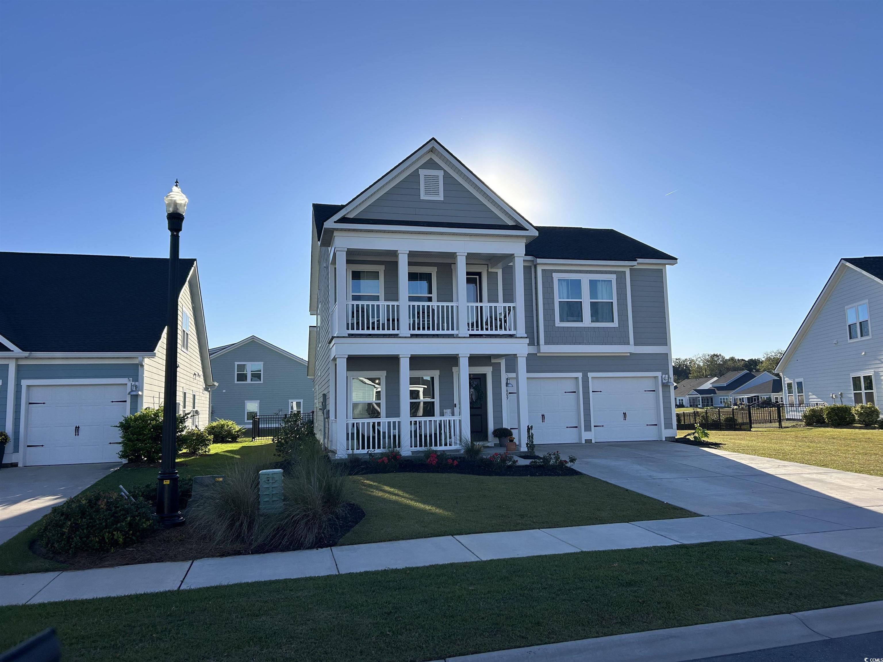 609 Shortleaf Path Myrtle Beach, SC 29577 - Photo 2 of 40 View of front of home featuring a porch, concrete driveway, and a garage