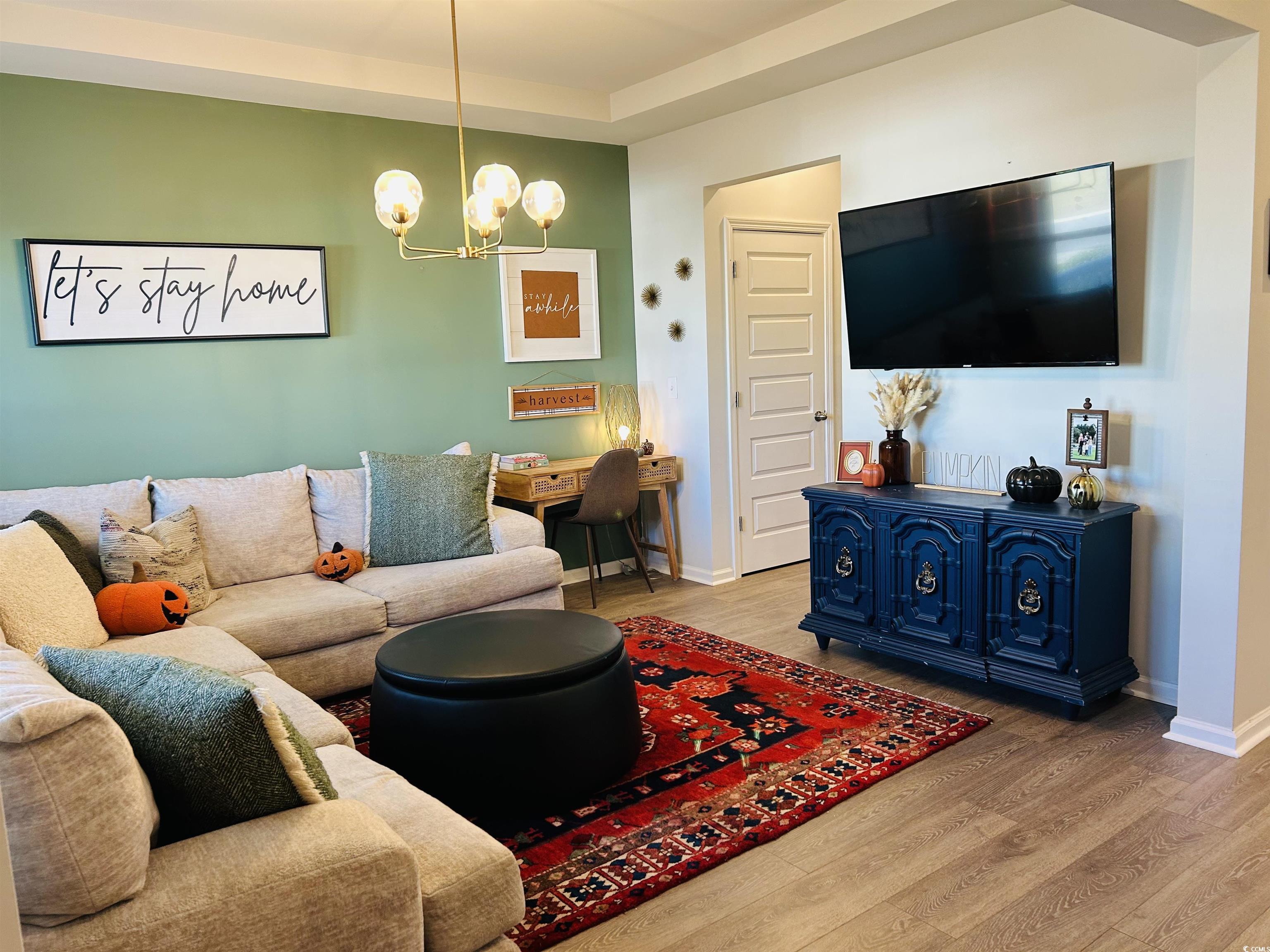 609 Shortleaf Path Myrtle Beach, SC 29577 - Photo 24 of 40 Living area featuring wood finished floors and a chandelier