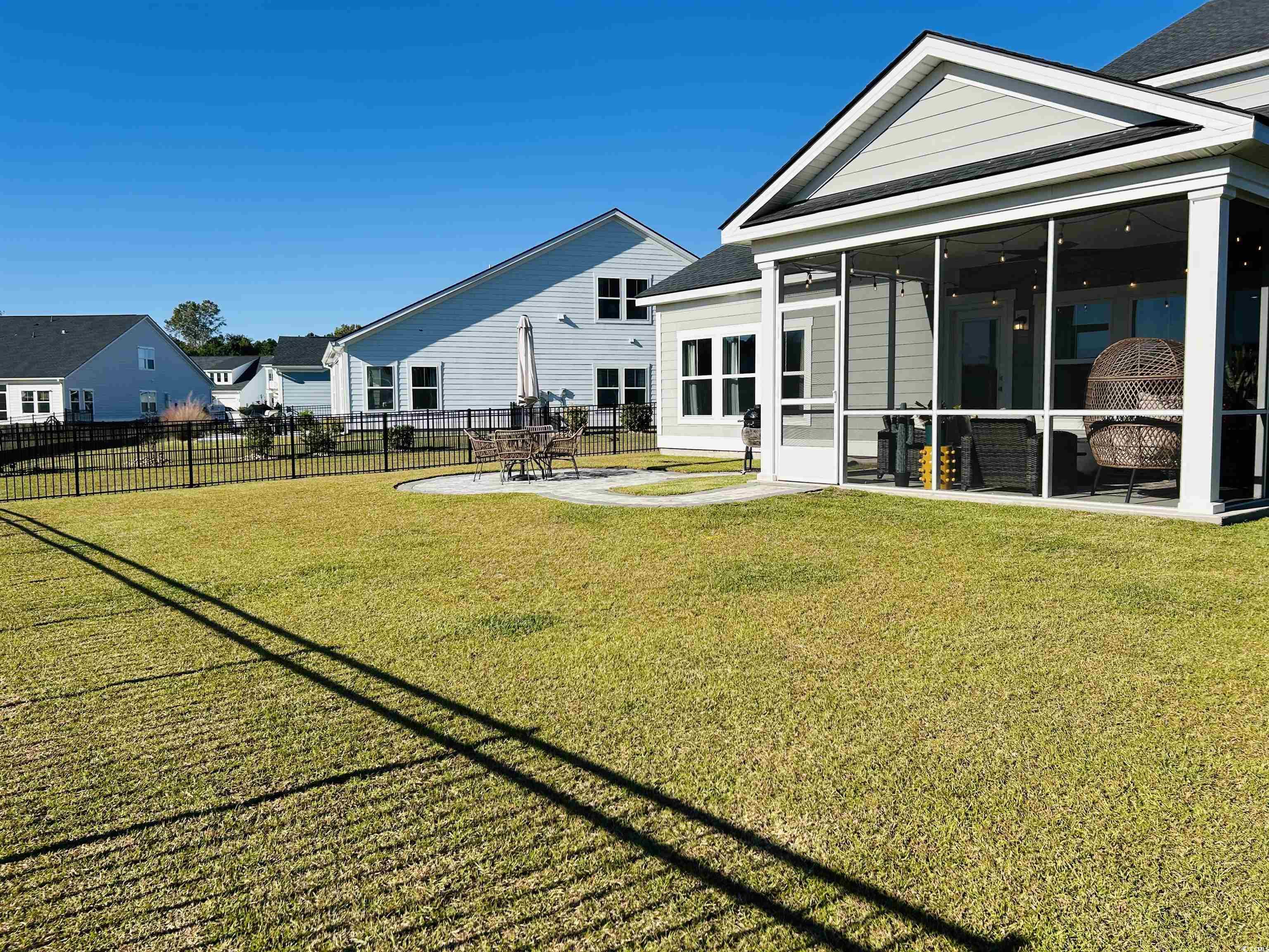 609 Shortleaf Path Myrtle Beach, SC 29577 - Photo 29 of 40 View of yard featuring a sunroom and a patio area