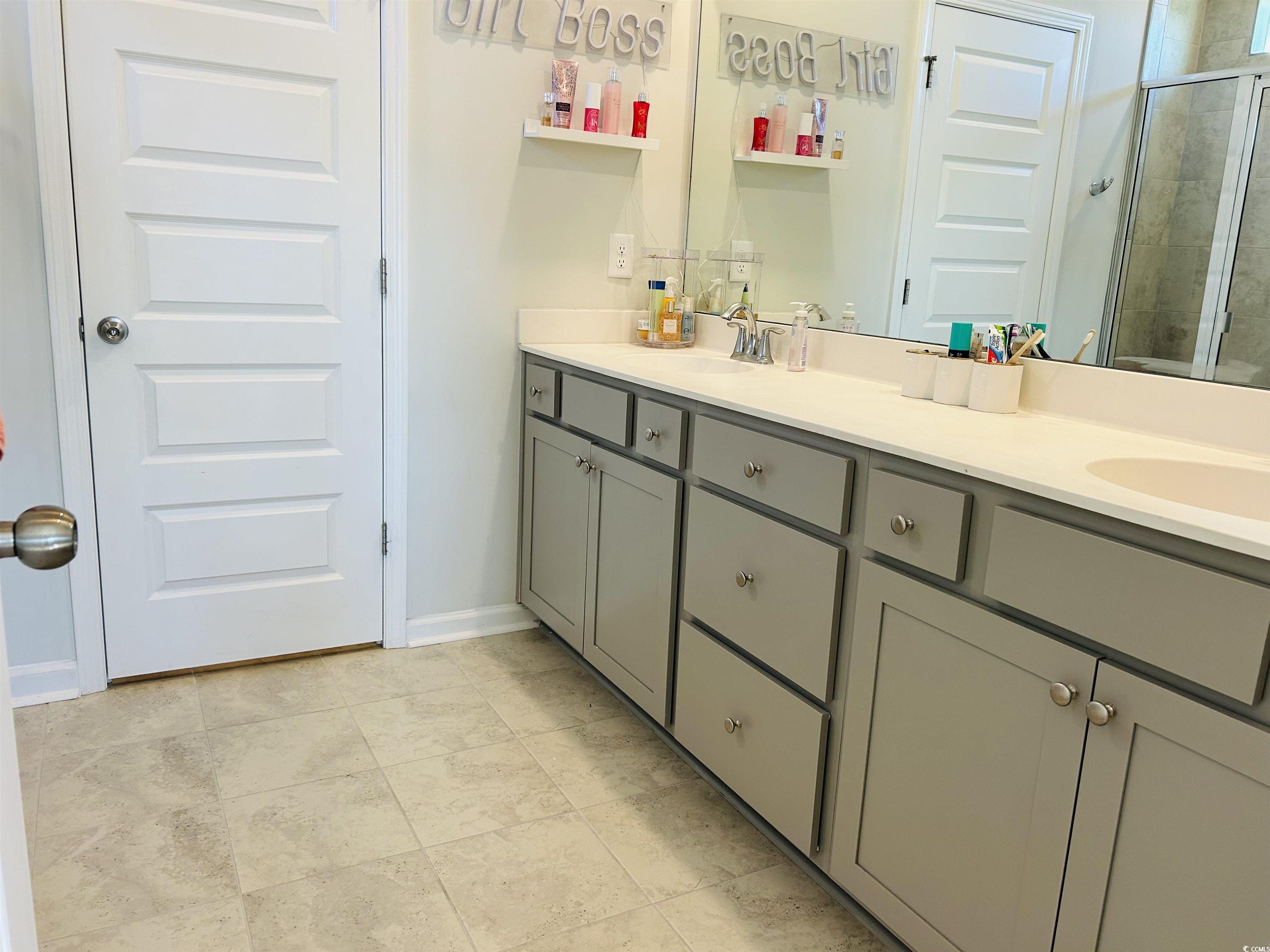 609 Shortleaf Path Myrtle Beach, SC 29577 - Photo 31 of 40 Bathroom featuring double vanity, a stall shower, and light tile patterned flooring