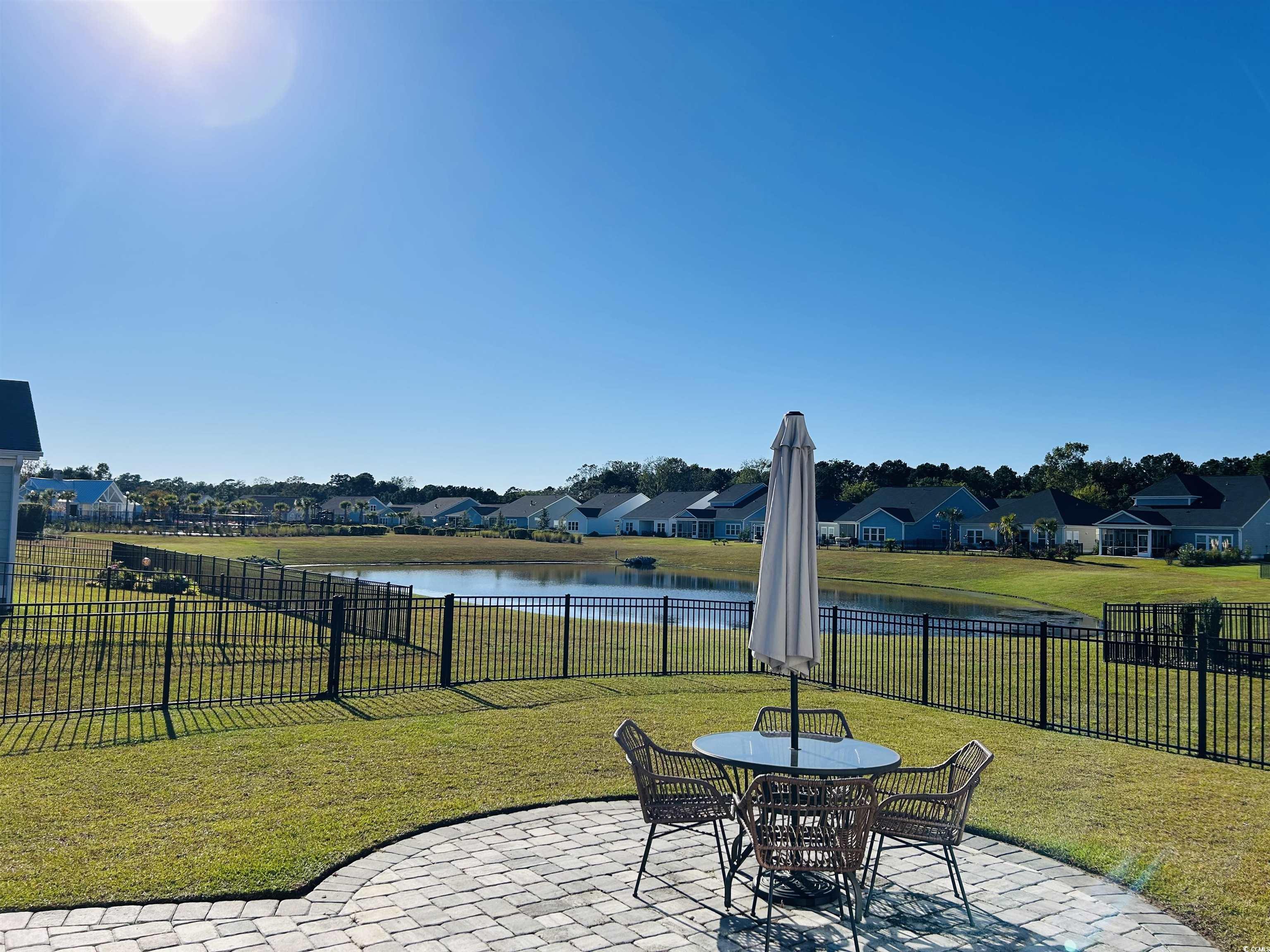 609 Shortleaf Path Myrtle Beach, SC 29577 - Photo 33 of 40 Fenced backyard with a patio area, a residential view, a water view, and outdoor dining area