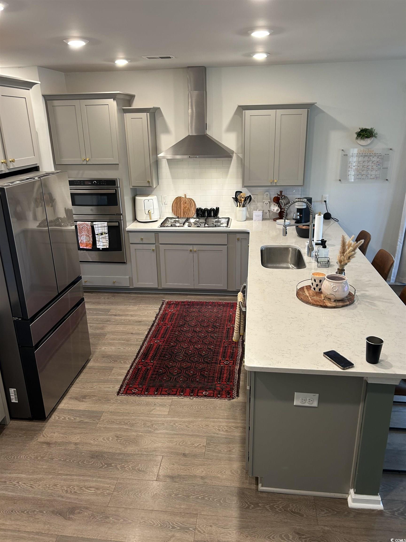 609 Shortleaf Path Myrtle Beach, SC 29577 - Photo 7 of 40 Kitchen featuring gray cabinets, stainless steel appliances, a peninsula, a breakfast bar, and recessed lighting