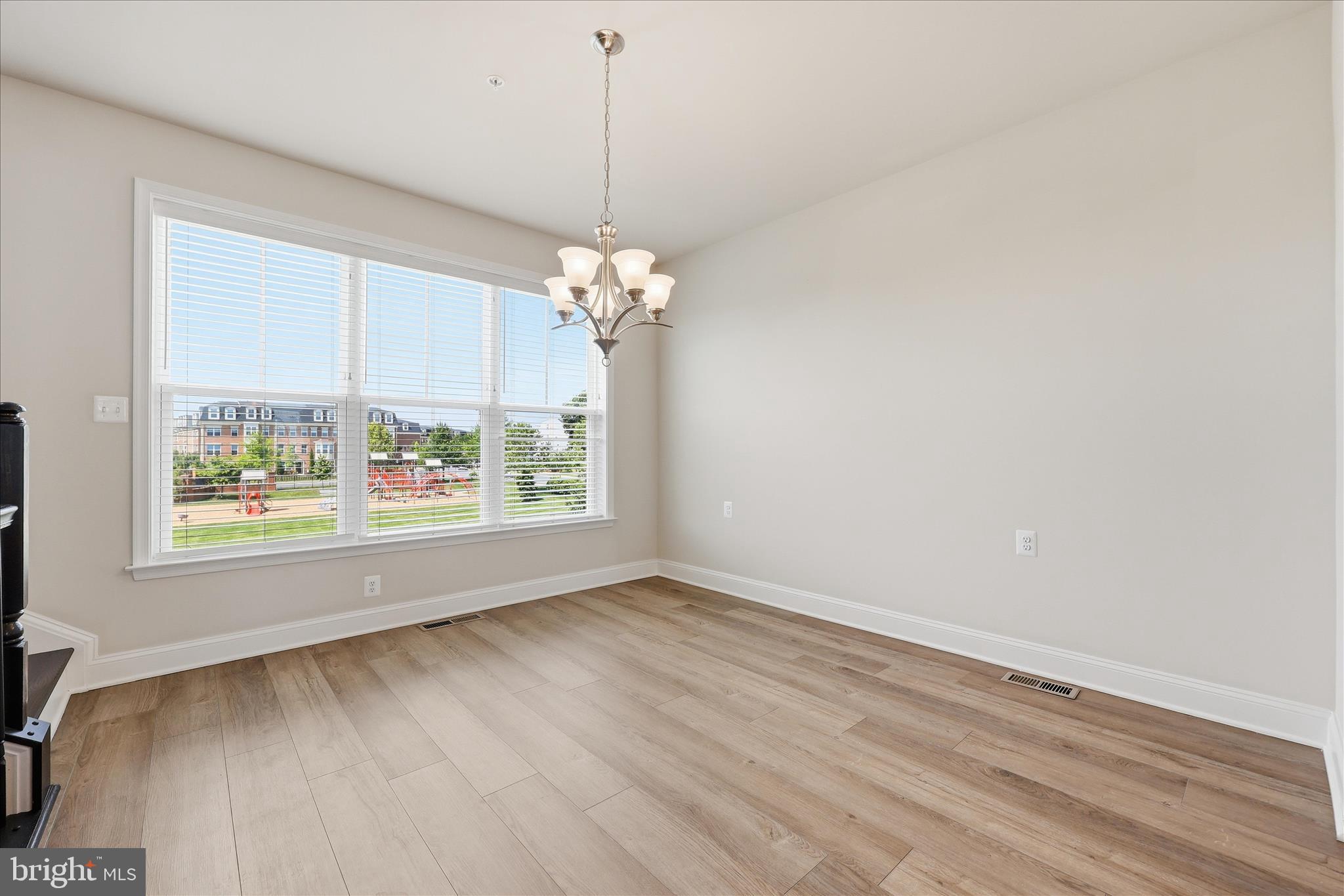 1090 Holden Road Frederick, MD 21701 - Photo 12 of 60 an empty room with wooden floor and windows