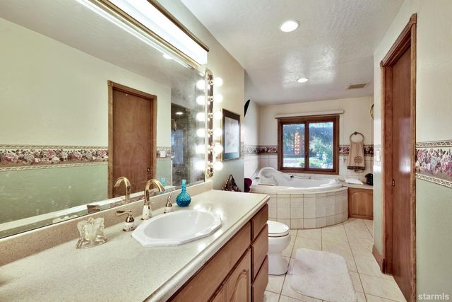 a large bathroom with a large tub and sink