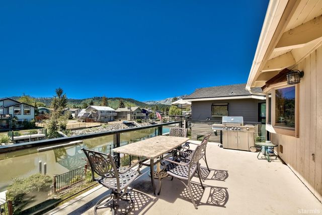 a view of a balcony with furniture and flat screen tv