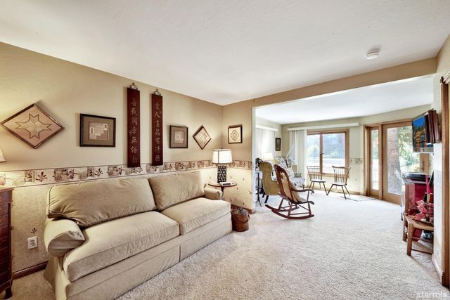 a living room with furniture or couch and a large window