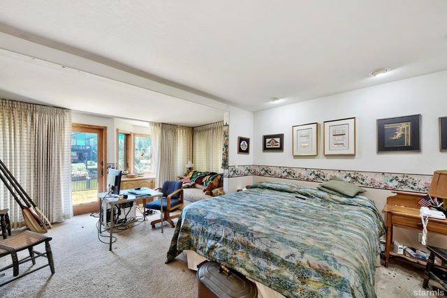 a bedroom with a bed a table and chair