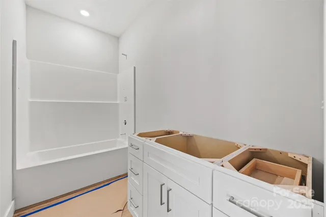 a view of a room with a ceiling fan and window