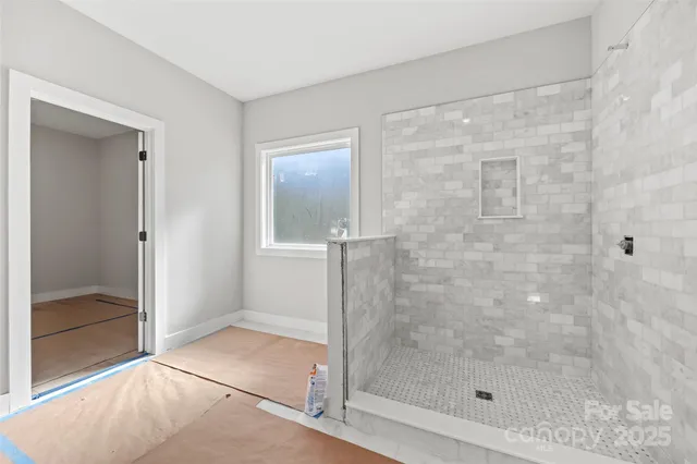 a room with bed and white walls