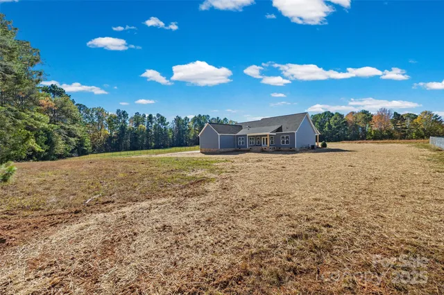 a front view of a house with yard and green space