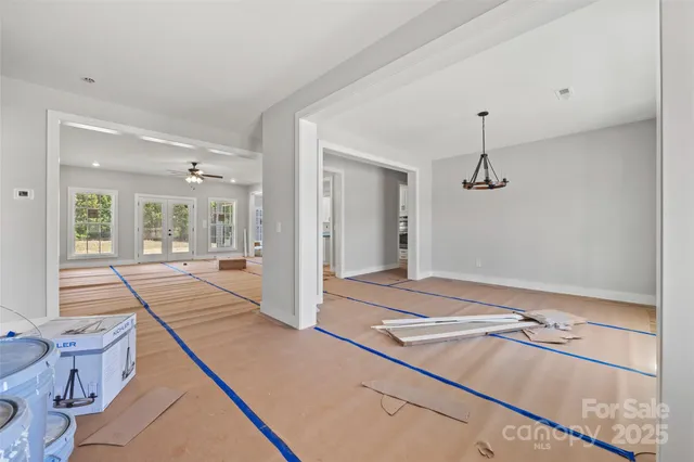 a view of a room with a large window and chandelier