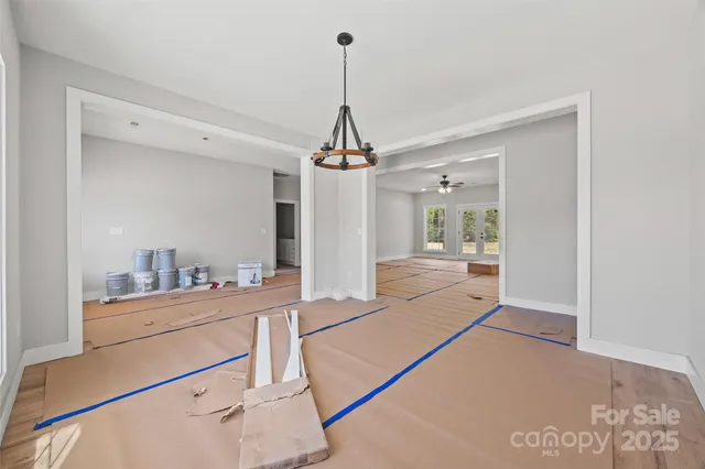 a spacious bedroom with double bed and a large window