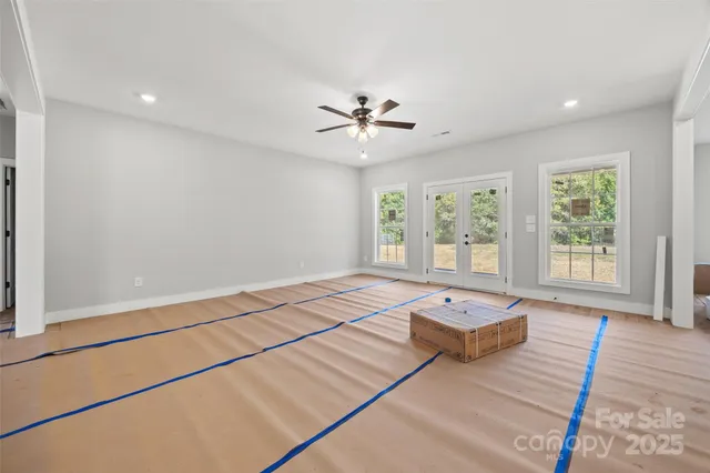 a large kitchen with kitchen island a stove a refrigerator and a dining table view