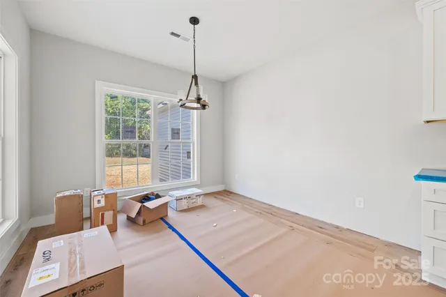 a living room with stainless steel appliances kitchen island granite countertop furniture and a view of kitchen