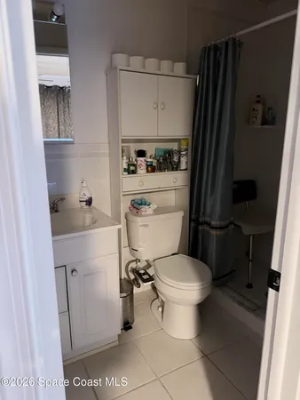 a white toilet sitting next to a bathroom sink