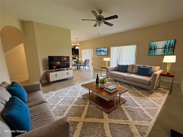 a living room with furniture a rug and a flat screen tv
