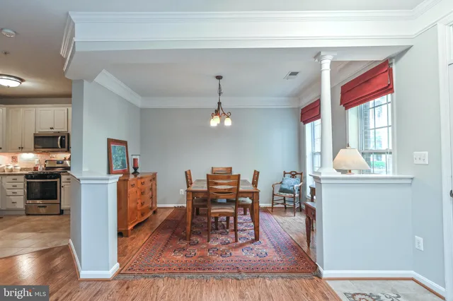a living room with furniture and a kitchen view
