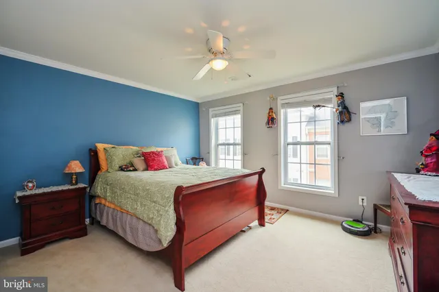 a bedroom with a bed dresser and a window