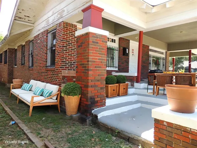 a view of a patio with couches chairs and potted plants