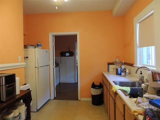 a kitchen with a sink and a stove top oven