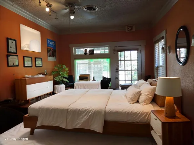 a bedroom with a large bed and a window