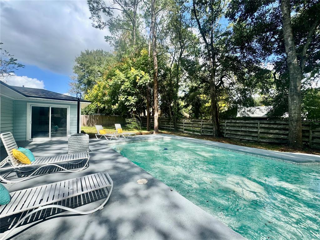 5407 Southwest 82 Terrace Gainesville, FL 32608 - Photo 26 of 31 a view of a chair and tables in the backyard