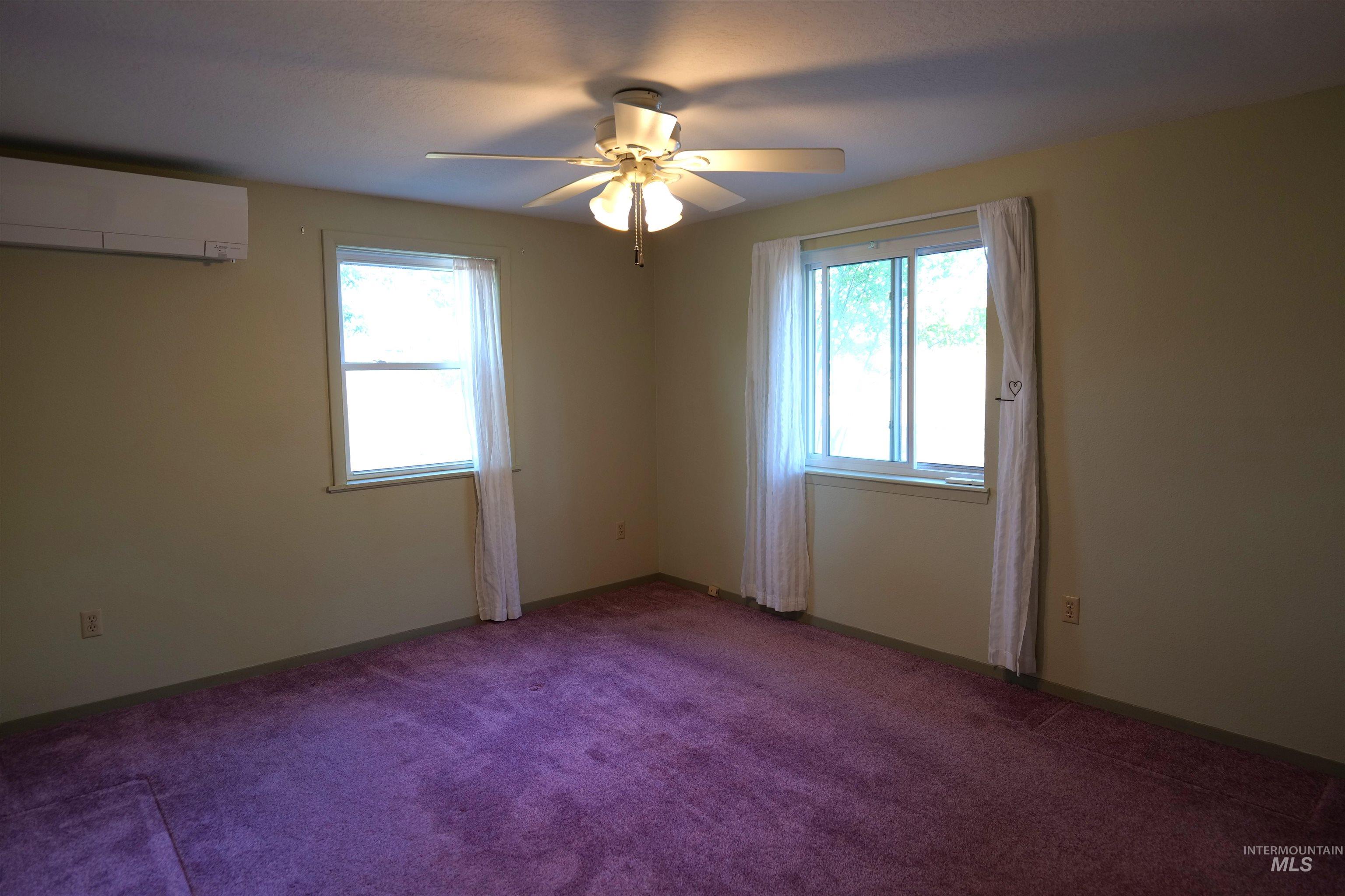 1485 East 9th Street Weiser, ID 83672 - Photo 5 of 18 Room featuring wall-to-wall carpeting, dual windows, and a ceiling fan