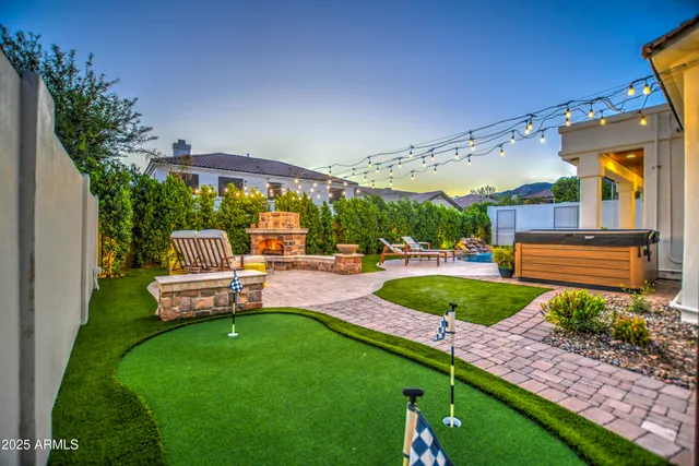 a view of a house with pool and chairs