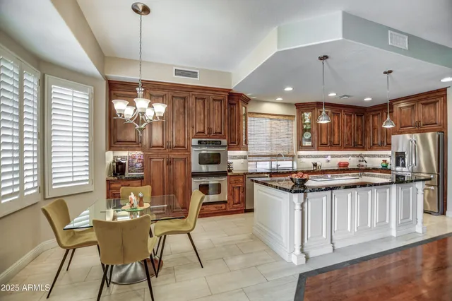 a kitchen with granite countertop a sink and a window