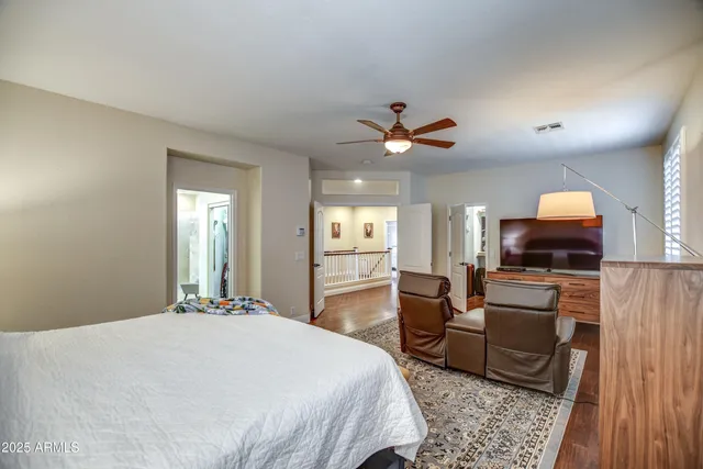 a bathroom with a sink a toilet a mirror and shower