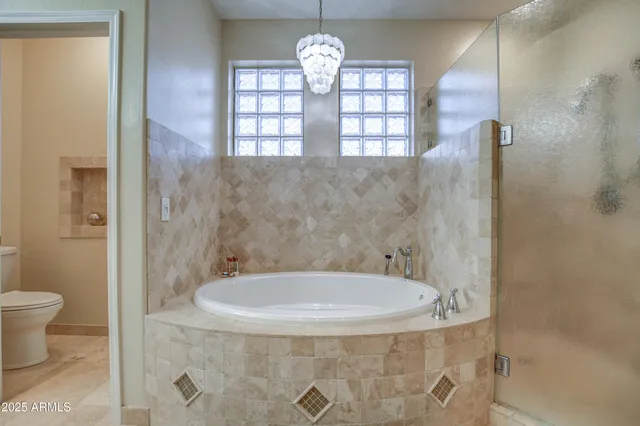 a room with chairs pool table and wooden floor