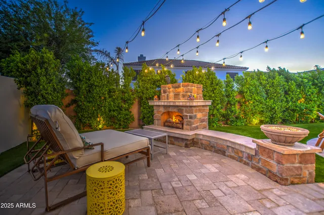 a view of a swimming pool with lawn chairs under an umbrella