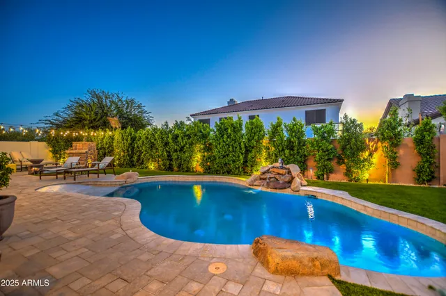 a swimming pool with outdoor seating and yard