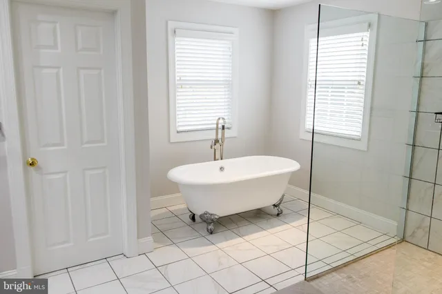 a spacious bathroom with a double vanity sink and a mirror