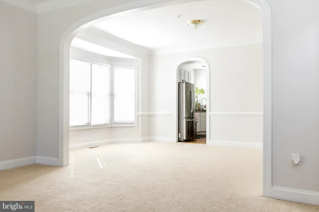 a kitchen with granite countertop a refrigerator stove top oven and sink