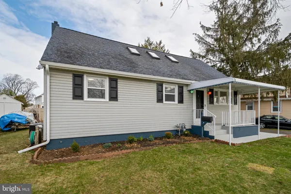 a view of a house with a swimming pool and a yard