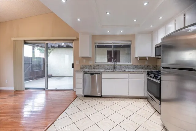 a kitchen with a sink stainless steel appliances and cabinets