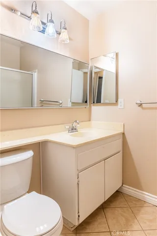 a bathroom with a sink mirror vanity and toilet