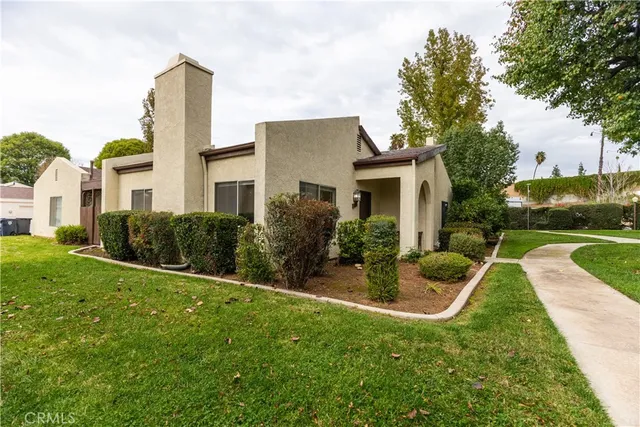 a view of a house with garden and a patio