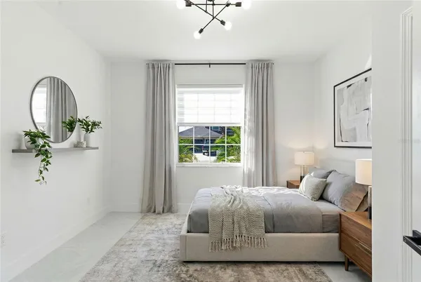 a bedroom with a bed and a potted plant