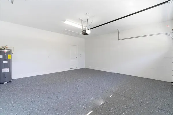 an empty room with a ceiling fan and window